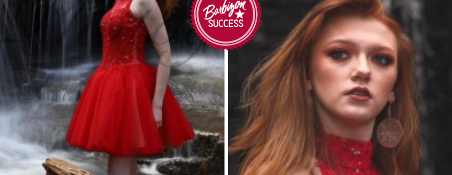 Aricca In A Red Dress Posing In Front Of A Waterfall For The Mentioned Magazine