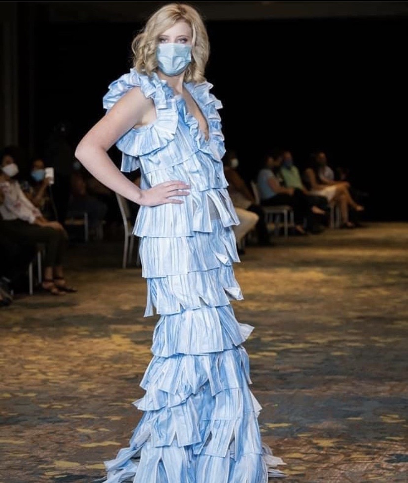 Paris Taylor Posing On The Runway In The Designer Dress And A Mask On Her Face