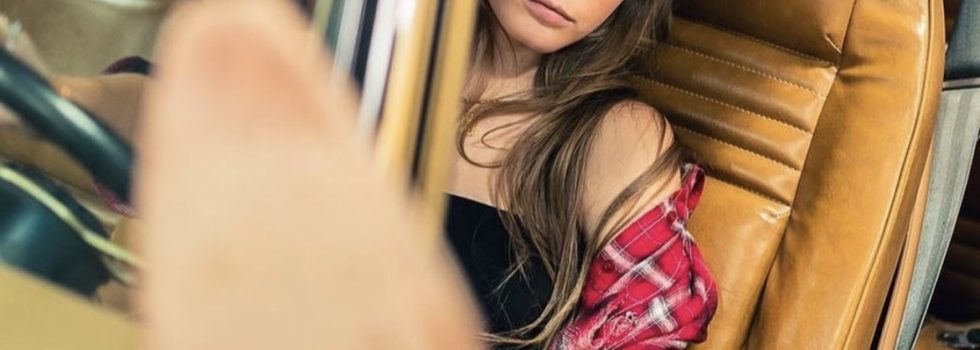 Mackenzie Modeling In A Car With Her Foot Out The Window From The Magazine Feature